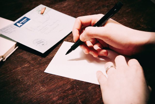 Hands Writing Letter