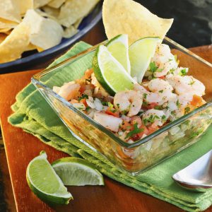 Close-up of tasty Ceviche cured with lime wedges