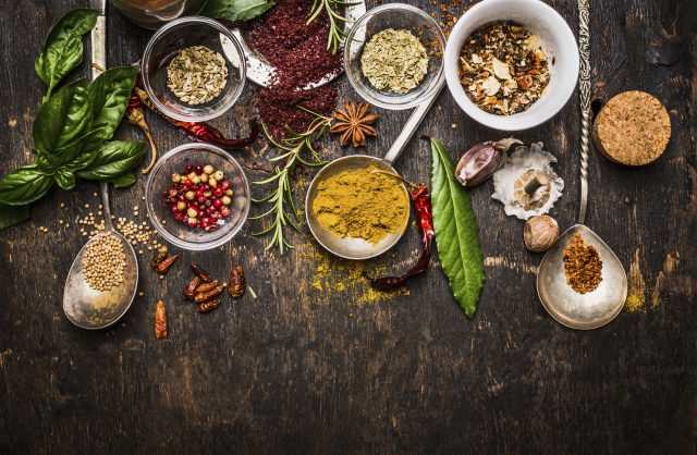 Dry colorful spices in spoons and cooking with tequila